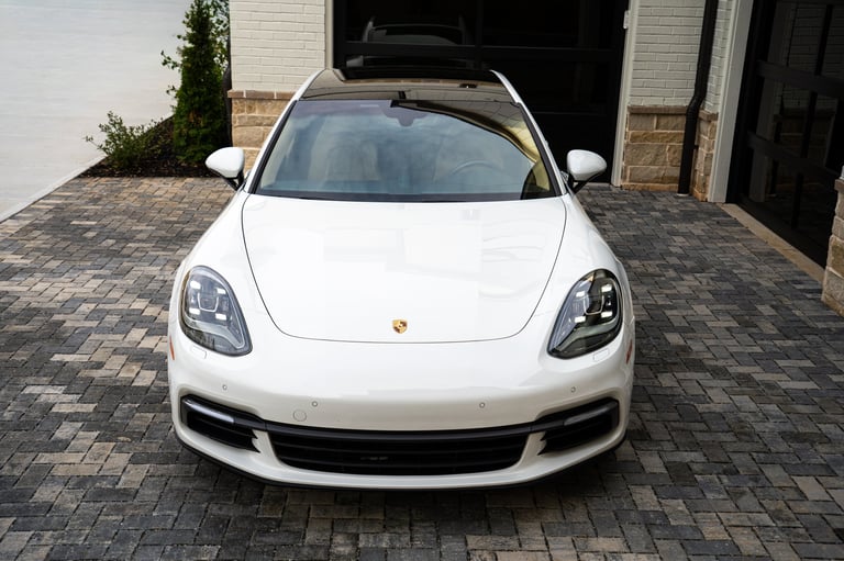 White Porsche sports car parked in a driveway