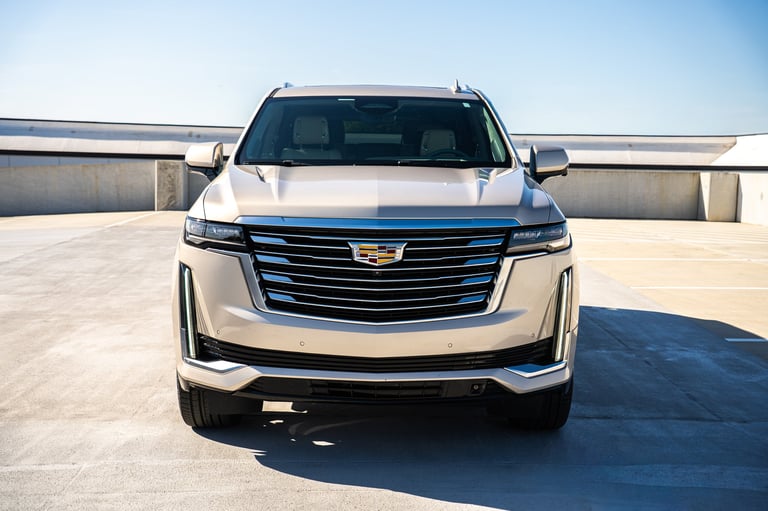 White Cadillac Escalade SUV parked on a concrete rooftop