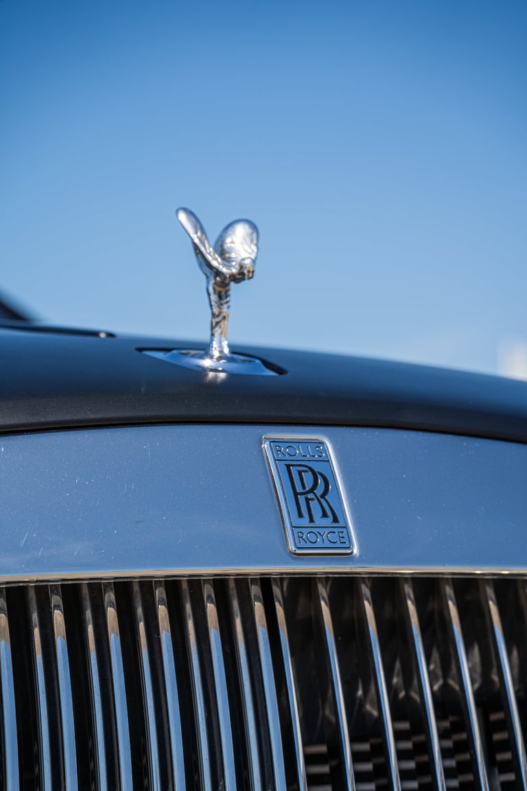 Rolls-Royce Wraith hood ornament and emblem against clear sky