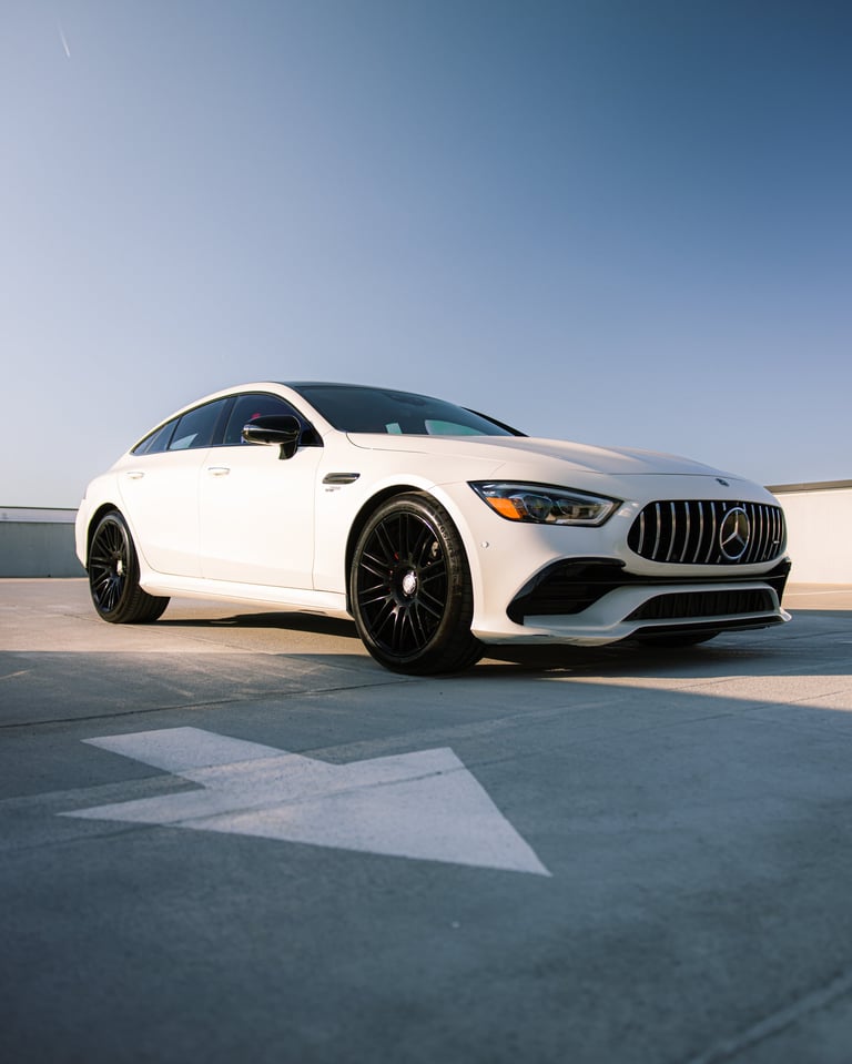 White Mercedes-AMG GT sedan parked on a rooftop