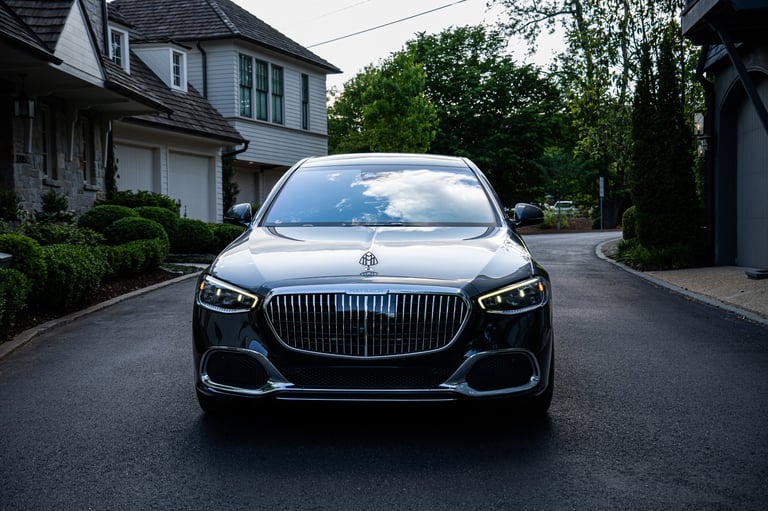 Luxury black sedan parked in a residential driveway