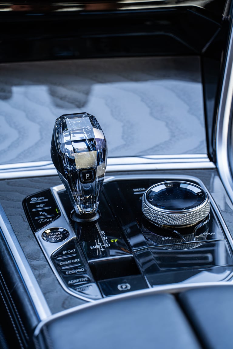Close-up of luxury car gear shift and controls on center console with modern design